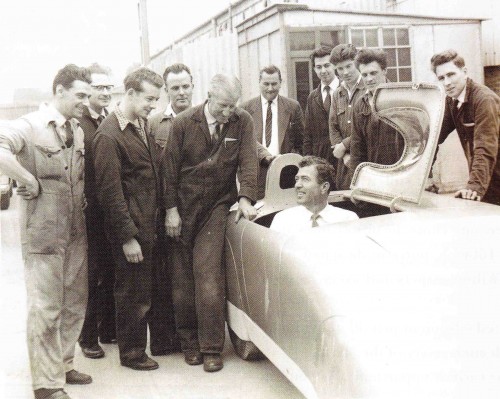 Carroll Shelby trying EX219 for size surrounded by development shop personnel